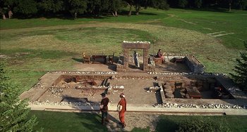 Movie still from “Robin Hood: Men in Tights” (1993), directed by Mel Brooks – Two men standing in front of an archeological site; Extreme Wide shot, High angle