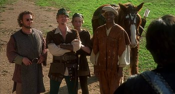 Movie still from “Robin Hood: Men in Tights” (1993), directed by Mel Brooks – A group of people dressed in medieval clothing; Medium shot, Over the shoulder angle