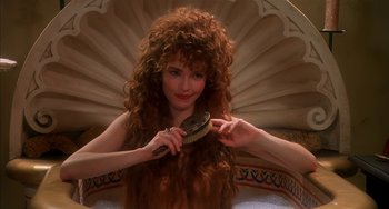 Movie still from “Robin Hood: Men in Tights” (1993), directed by Mel Brooks – A woman brushing her long red hair with a brush; Close Up shot, High angle