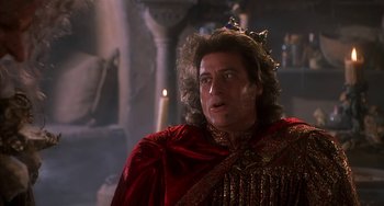 Movie still from “Robin Hood: Men in Tights” (1993), directed by Mel Brooks – A person wearing a robe and crown; Close Up shot, Low angle