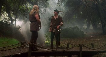 Movie still from “Robin Hood: Men in Tights” (1993), directed by Mel Brooks – A man and a woman dressed as robin hood and his merry men in the woods; Wide shot, Over the shoulder angle