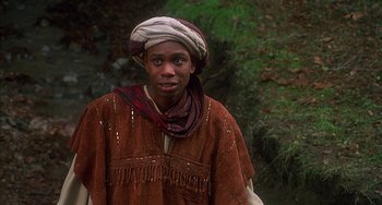 Movie still from “Robin Hood: Men in Tights” (1993), directed by Mel Brooks – A man wearing a head covering and a brown jacket; Close Up shot, Low angle