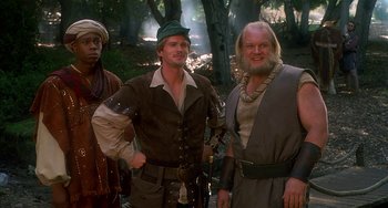 Movie still from “Robin Hood: Men in Tights” (1993), directed by Mel Brooks – A group of men standing next to each other in the woods; Medium shot, Low angle
