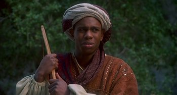 Movie still from “Robin Hood: Men in Tights” (1993), directed by Mel Brooks – A man in a turban holding a bow and arrow; Close Up shot, Low angle