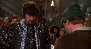 Movie still from “Robin Hood: Men in Tights” (1993), directed by Mel Brooks – A person wearing a costume; Medium shot, Over the shoulder angle