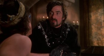 Movie still from “Robin Hood: Men in Tights” (1993), directed by Mel Brooks – A man wearing a black shirt with stars on it; Medium shot, Over the shoulder angle
