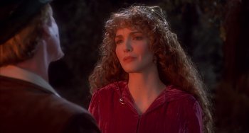 Movie still from “Robin Hood: Men in Tights” (1993), directed by Mel Brooks – A woman with long red curly hair wearing a red jacket; Close Up shot, Over the shoulder angle