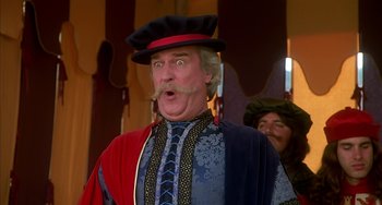 Movie still from “Robin Hood: Men in Tights” (1993), directed by Mel Brooks – A person with a mustache wearing a hat; Close Up shot, Low angle