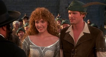 Movie still from “Robin Hood: Men in Tights” (1993), directed by Mel Brooks – A man and a woman standing next to each other; Close Up shot, Over the shoulder angle