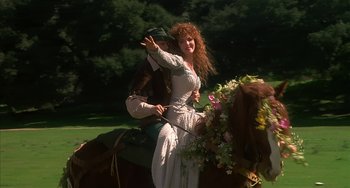Movie still from “Robin Hood: Men in Tights” (1993), directed by Mel Brooks – A man and a woman riding on a horse; Medium shot, Low angle