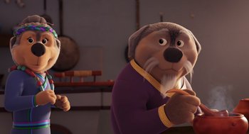 Movie still from “Rock Dog 2: Rock Around the Park” (2021), directed by Mark Baldo – A cartoon dog wearing a purple shirt and a white shirt; Close Up shot, Over the shoulder angle