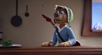 Movie still from “Rock Dog 2: Rock Around the Park” (2021), directed by Mark Baldo – A cartoon dog holding a guitar in his mouth; Medium shot, High angle