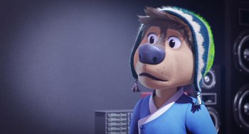 Movie still from “Rock Dog 2: Rock Around the Park” (2021), directed by Mark Baldo – A cartoon dog wearing a blue shirt and a hat; Close Up shot, Over the shoulder angle