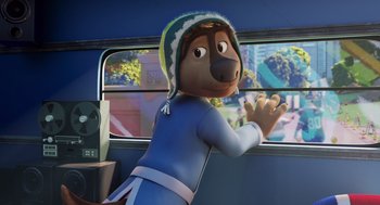 Movie still from “Rock Dog 2: Rock Around the Park” (2021), directed by Mark Baldo – A man in a dog costume on a bus; Medium shot, High angle