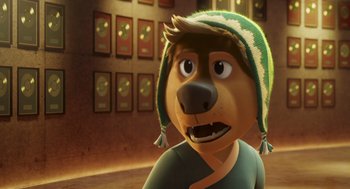 Movie still from “Rock Dog 2: Rock Around the Park” (2021), directed by Mark Baldo – A cartoon dog wearing a green and white hat; Close Up shot, Over the shoulder angle