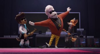 Movie still from “Rock Dog 2: Rock Around the Park” (2021), directed by Mark Baldo – A group of people standing next to each other on a stage; Wide shot, Low angle