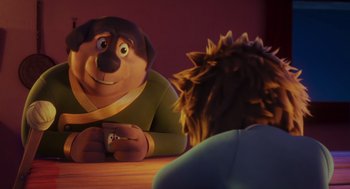 Movie still from “Rock Dog 2: Rock Around the Park” (2021), directed by Mark Baldo – A dog sitting next to a person on a wooden table; Close Up shot, Over the shoulder angle