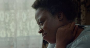 Movie still from “Rocks” (2019), directed by Sarah Gavron – A person with their hand on his shoulder; Close Up shot, Over the shoulder angle