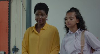 Movie still from “Rocks” (2019), directed by Sarah Gavron – A woman and a girl standing next to each other; Medium shot, Over the shoulder angle