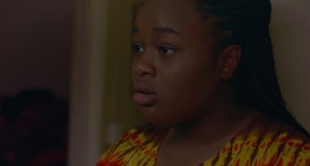 Movie still from “Rocks” (2019), directed by Sarah Gavron – A person looking at the camera; Close Up shot, Over the shoulder angle