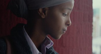 Movie still from “Rocks” (2019), directed by Sarah Gavron – A person wearing a neck tie; Close Up shot, Low angle