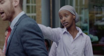 Movie still from “Rocks” (2019), directed by Sarah Gavron – A young woman wearing a headscarf is looking at a man; Close Up shot, Over the shoulder angle