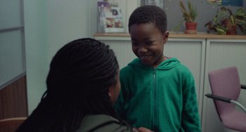 Movie still from “Rocks” (2019), directed by Sarah Gavron – A young boy and a young woman smiling at each other; Medium shot, Over the shoulder angle