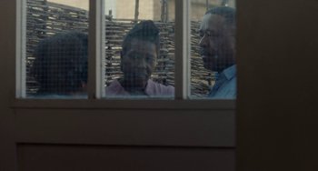 Movie still from “Rocks” (2019), directed by Sarah Gavron – Two people are looking out a window at each other; Medium shot, Over the shoulder angle
