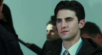 Movie still from “Rocky Balboa” (2006), directed by Sylvester Stallone – A man in a suit and tie looking at the camera; Close Up shot, Over the shoulder angle