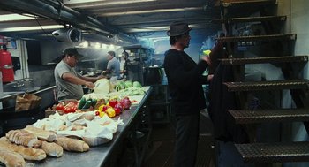 Movie still from “Rocky Balboa” (2006), directed by Sylvester Stallone – A group of people preparing food inside of a kitchen; Medium shot, Over the shoulder angle