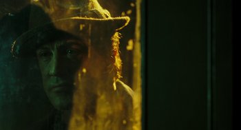Movie still from “Rocky Balboa” (2006), directed by Sylvester Stallone – A man wearing a hat looking out of a window; Close Up shot, Over the shoulder angle