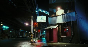 Movie still from “Rocky Balboa” (2006), directed by Sylvester Stallone – A street corner at night with a sign for lucky seven tavern on it; Extreme Wide shot, High angle