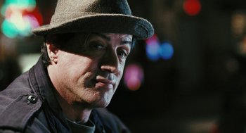 Movie still from “Rocky Balboa” (2006), directed by Sylvester Stallone – A person wearing a hat; Close Up shot, Over the shoulder angle