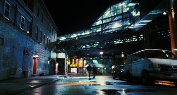 Movie still from “Rocky Balboa” (2006), directed by Sylvester Stallone – A person with an umbrella walking on the street at night; Extreme Wide shot, Low angle