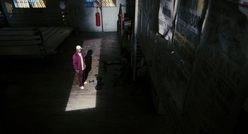 Movie still from “Rocky Balboa” (2006), directed by Sylvester Stallone – A man standing in the middle of an alley way; Wide shot, Overhead angle
