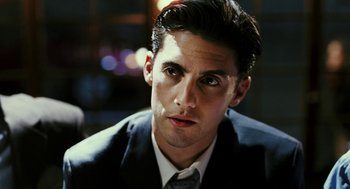 Movie still from “Rocky Balboa” (2006), directed by Sylvester Stallone – A person wearing a suit and tie; Close Up shot, Over the shoulder angle