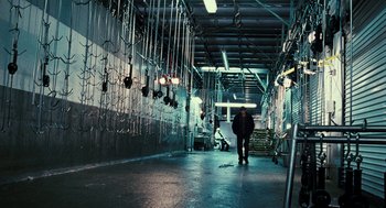 Movie still from “Rocky Balboa” (2006), directed by Sylvester Stallone – A man walking down a walkway in a building; Wide shot, High angle