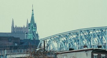 Movie still from “Rocky Balboa” (2006), directed by Sylvester Stallone – A bridge with a large building in the background; Extreme Wide shot, Low angle