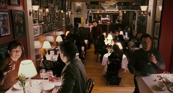 Movie still from “Rocky Balboa” (2006), directed by Sylvester Stallone – People are sitting at tables in a restaurant; Wide shot, Over the shoulder angle