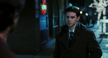 Movie still from “Rocky Balboa” (2006), directed by Sylvester Stallone – A man in a coat and tie standing on the sidewalk; Close Up shot, Over the shoulder angle
