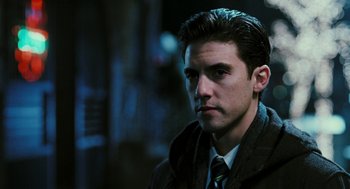 Movie still from “Rocky Balboa” (2006), directed by Sylvester Stallone – A man in a jacket and tie looking at the camera; Close Up shot, Over the shoulder angle