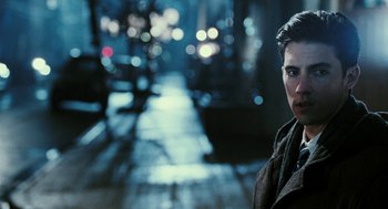 Movie still from “Rocky Balboa” (2006), directed by Sylvester Stallone – A man standing on a street at night with lights in the background; Close Up shot, Over the shoulder angle