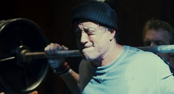 Movie still from “Rocky Balboa” (2006), directed by Sylvester Stallone – A man holding a wooden stick in his mouth; Close Up shot, Over the shoulder angle