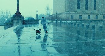 Movie still from “Rocky Balboa” (2006), directed by Sylvester Stallone – A person walking a dog in the rain; Wide shot, High angle