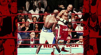 Movie still from “Rocky Balboa” (2006), directed by Sylvester Stallone – Two boxers in a boxing ring during a match; Medium shot, High angle