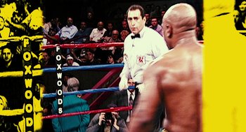 Movie still from “Rocky Balboa” (2006), directed by Sylvester Stallone – A man in a boxing ring with a referee behind him; Medium shot, High angle