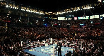 Movie still from “Rocky Balboa” (2006), directed by Sylvester Stallone – A boxing ring filled with people in a boxing ring; Extreme Wide shot, High angle