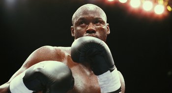 Movie still from “Rocky Balboa” (2006), directed by Sylvester Stallone – A person wearing boxing gloves; Close Up shot, Low angle
