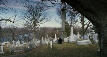 Movie still from “Rocky Balboa” (2006), directed by Sylvester Stallone – A cat sitting on the ground in front of a cemetery; Extreme Wide shot, High angle