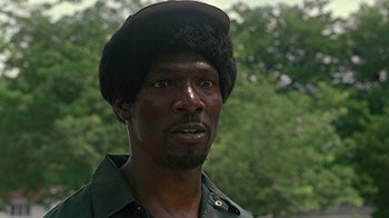Movie still from “Roll Bounce” (2005), directed by Malcolm D. Lee – A person wearing a hat; Close Up shot, Over the shoulder angle